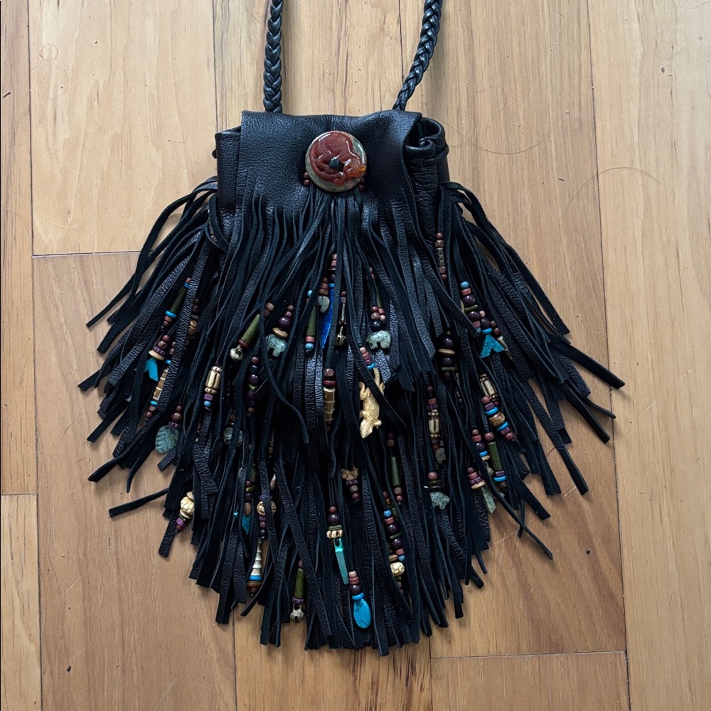 Hand crafted leather satchel with semi precious stones and carved beads.